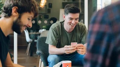 Mike and Tom share a joke during a game of cards
